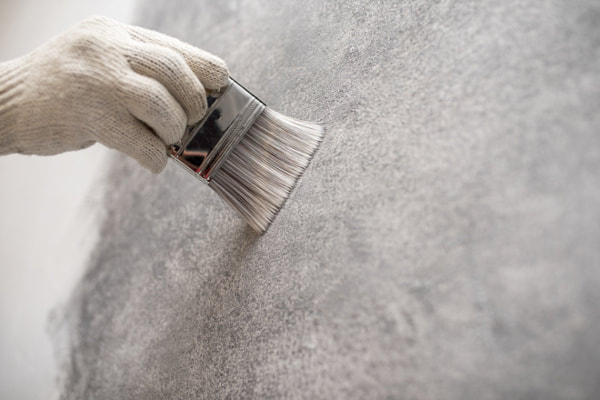 Painting contractor displaying a new paint technique on a wall